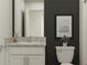 A half-bathroom features a granite countertop, a white vanity and a picture hanging above the toilet at 10225 Trumpet Honeysuckle Way, San Antonio, FL 33576