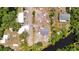 Aerial view of property highlighting boundaries with a gray home, neighboring creek, and mature trees at 11009 Spivey Rd # 1, Gibsonton, FL 33534