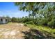 A serene view of the backyard with lush greenery bordering a tranquil body of water at 11009 Spivey Rd # 1, Gibsonton, FL 33534