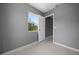 This bedroom has fresh paint, light tile floors and a bright window and door leading to another room at 11009 Spivey Rd # 1, Gibsonton, FL 33534