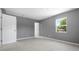 Spacious bedroom with white trim, light tile floors and a bright window view at 11009 Spivey Rd # 1, Gibsonton, FL 33534