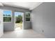 Bright room boasts fresh paint, light tile floors and a door with two windows to the backyard at 11009 Spivey Rd # 1, Gibsonton, FL 33534