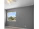 Bedroom with ceiling fan, window with a view and light-colored tile flooring at 11009 Spivey Rd # 1, Gibsonton, FL 33534