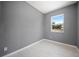 Cozy bedroom features fresh paint, light tile floors and a window with bright green views at 11009 Spivey Rd # 1, Gibsonton, FL 33534