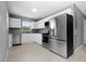 Modern kitchen with stainless steel appliances, white cabinets, and sleek countertops at 11009 Spivey Rd # 1, Gibsonton, FL 33534