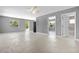 Spacious living room with tile flooring, neutral paint, ceiling fan and access to bathroom at 11009 Spivey Rd # 1, Gibsonton, FL 33534