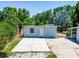 Spacious backyard with concrete area and lots of trees around providing privacy and shade at 1221 E Hamilton Ave, Tampa, FL 33604