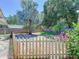 Spacious backyard featuring a screened patio, lush lawn, and mature trees at 1221 E Hamilton Ave, Tampa, FL 33604