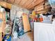 Unfinished basement with concrete block walls and storage shelving, including a washer and dryer at 1221 E Hamilton Ave, Tampa, FL 33604