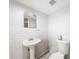 Bright bathroom with a vintage faucet sink, white subway tiles, and black and white mosaic floors at 1221 E Hamilton Ave, Tampa, FL 33604