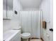 Clean bathroom with a white shower curtain, vanity, and towel rack creating a cozy atmosphere at 1221 E Hamilton Ave, Tampa, FL 33604
