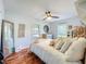 Comfortable bedroom with hardwood floors and bright windows features a well-lit room with a ceiling fan at 1221 E Hamilton Ave, Tampa, FL 33604