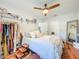 Cozy bedroom with wood floors and ceiling fan features a comfortable bed and ample closet space at 1221 E Hamilton Ave, Tampa, FL 33604