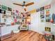 Unique bedroom featuring laminate floors, a ceiling fan, and walls adorned with vintage vinyl records at 1221 E Hamilton Ave, Tampa, FL 33604