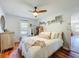 Bright and inviting bedroom featuring a comfortable bed, hardwood floors, and ample natural light at 1221 E Hamilton Ave, Tampa, FL 33604