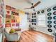 Fun decorated bedroom featuring hardwood floors, record albums on the wall and natural light at 1221 E Hamilton Ave, Tampa, FL 33604