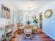 Bright dining room featuring hardwood floors, stylish decor, and a modern chandelier at 1221 E Hamilton Ave, Tampa, FL 33604