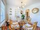 Bright dining room with hardwood floors, stylish decor, shelving, and plenty of natural light at 1221 E Hamilton Ave, Tampa, FL 33604