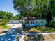 Charming single-story home with a well-manicured front yard, mature trees, and a long driveway at 1221 E Hamilton Ave, Tampa, FL 33604