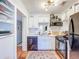 Efficient kitchen with white cabinets, open shelving and stainless steel appliances, plus adjacent dining space at 1221 E Hamilton Ave, Tampa, FL 33604