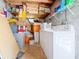 Functional laundry room with washer, dryer, and shelving filled with supplies and plenty of storage space at 1221 E Hamilton Ave, Tampa, FL 33604