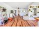 Bright living room featuring hardwood floors, lots of decor and plants with natural light creating a serene atmosphere at 1221 E Hamilton Ave, Tampa, FL 33604