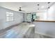Open living space with wood floors, a sliding barn door, modern lighting, and an airy feel at 1221 E Hamilton Ave, Tampa, FL 33604