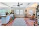 Spacious living space featuring hardwood floors, ceiling fan, breakfast bar, and lots of natural light at 1221 E Hamilton Ave, Tampa, FL 33604