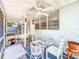 Inviting covered patio features a ceiling fan, outdoor seating, and access to the backyard at 1221 E Hamilton Ave, Tampa, FL 33604