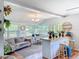 Inviting sunroom with a vintage rug, a desk and chairs, and a lovely bar with stools for seating at 1221 E Hamilton Ave, Tampa, FL 33604