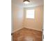 A small bedroom with tile floors, a window, and white walls at 12907 N 53Rd St, Temple Terrace, FL 33617