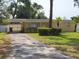 Charming single-story home featuring a quaint front yard and an inviting driveway at 12907 N 53Rd St, Temple Terrace, FL 33617