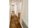 Hallway with tile floors, white trim, and a view of a room at the end at 12907 N 53Rd St, Temple Terrace, FL 33617