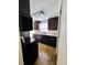 A kitchen featuring dark wood cabinets, tile flooring, and stainless steel appliances at 12907 N 53Rd St, Temple Terrace, FL 33617