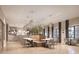 Elegant dining area featuring modern lighting, contemporary furniture, and a view of the bar at 12961 Shining Blue Nile Ln, Parrish, FL 34219