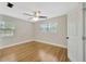 This bedroom offers hardwood floors, two windows, and ample natural light at 1304 N Ferrell St, Plant City, FL 33563