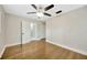 This bedroom is equipped with hardwood floors, a ceiling fan, and closet space at 1304 N Ferrell St, Plant City, FL 33563