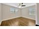This bedroom features hardwood floors and natural light from two windows at 1304 N Ferrell St, Plant City, FL 33563