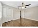 This is a well-lit bedroom with hardwood floors and a closet at 1304 N Ferrell St, Plant City, FL 33563