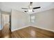 This is a bedroom with hardwood floors, a ceiling fan, and bright natural light at 1304 N Ferrell St, Plant City, FL 33563