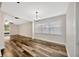 Bright dining room featuring hardwood floors, ample natural light, and modern lighting fixture at 1304 N Ferrell St, Plant City, FL 33563