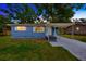 Charming blue home featuring a covered carport, well-maintained lawn, and a welcoming facade at 1304 N Ferrell St, Plant City, FL 33563