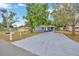 Traditional style home with a long driveway, featuring a well-manicured lawn and a carport at 1304 N Ferrell St, Plant City, FL 33563