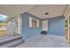 Covered front porch with a tiled entryway, features the main door, and an additional entry point at 1304 N Ferrell St, Plant City, FL 33563