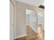 Hallway with hardwood flooring, neutral paint, and entry to other rooms at 1304 N Ferrell St, Plant City, FL 33563