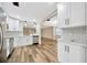 Well-lit kitchen with stainless appliances, sleek white cabinets, and open view to the dining area at 1304 N Ferrell St, Plant City, FL 33563