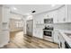 Modern kitchen with stainless steel appliances, white cabinets, and stylish backsplash at 1304 N Ferrell St, Plant City, FL 33563