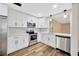 Updated kitchen featuring stainless steel appliances, white cabinets, and stylish backsplash tiles at 1304 N Ferrell St, Plant City, FL 33563