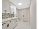Bright laundry room with white cabinets, stylish backsplash, and ample storage space at 1304 N Ferrell St, Plant City, FL 33563