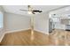 Bright living room featuring hardwood floors, a ceiling fan, and an open layout to the modern kitchen at 1304 N Ferrell St, Plant City, FL 33563